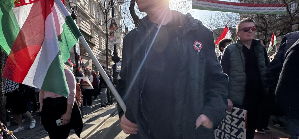 People wearing Hungarian cockades and carrying flags during the 15th of March celebration of the 1848 revolution in Budapest