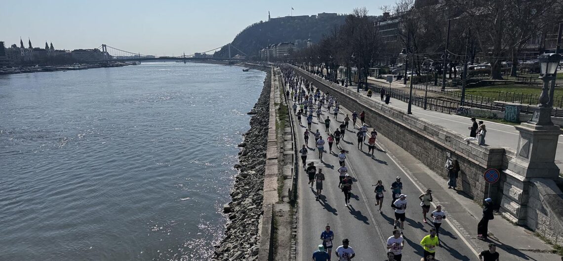 Runners enjoying the Budapest half marathon route along the Danube on a sunny spring day