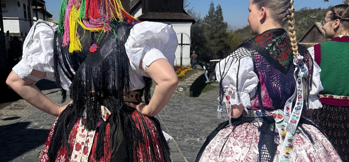 Women wearing traditional Hungarian folk costumes during Easter celebrations in Hollókő village