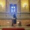 Grand staircase inside the Hungarian State Opera House in Budapest, with marble columns, gold details, and red carpet.