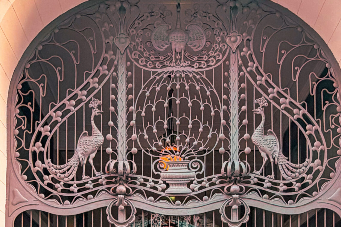 Decorative Art Nouveau peacock motif on the wrought-iron gate of Gresham Palace in Budapest