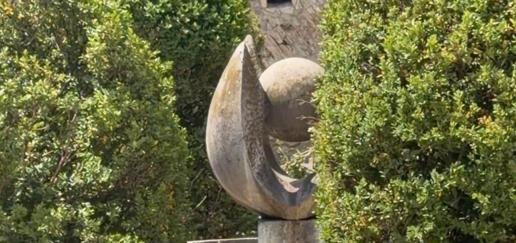 Sculpture among trees in one of the hidden gardens in Buda Castle, Budapest