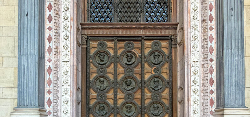 The monumental bronze entrance of St. Stephen's Basilica, one of the most beautiful entrances in Budapest.