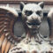 Winged mythical creature hidden among the architecture details of a historic Budapest building.