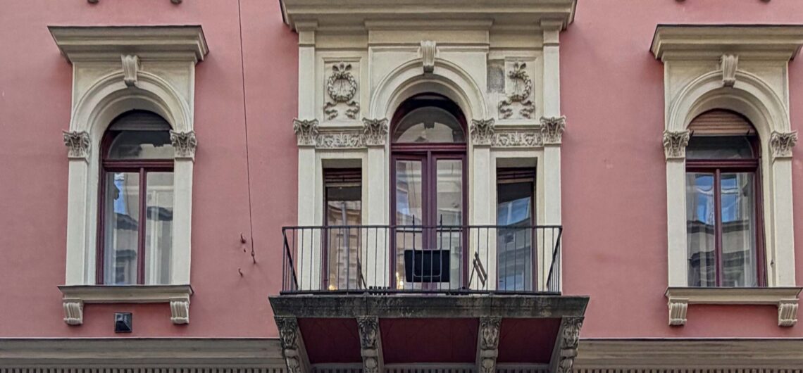Single balcony on a historic Budapest building façade