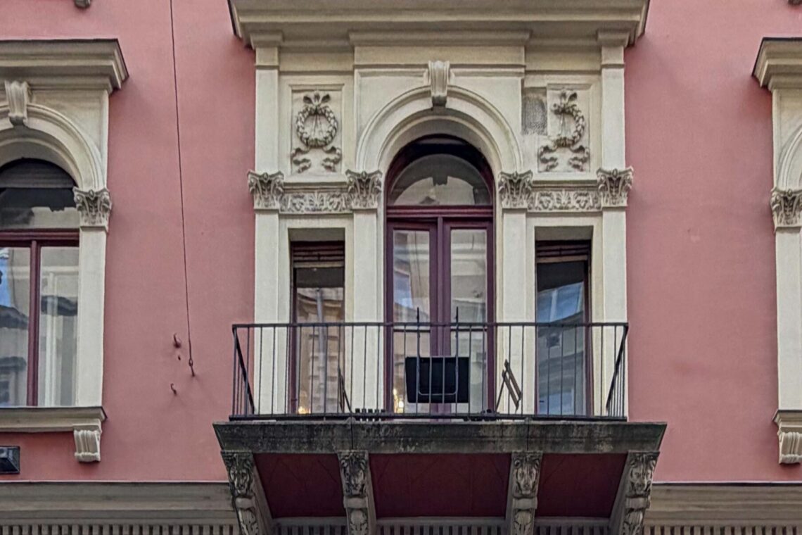 Single balcony on a historic Budapest building façade