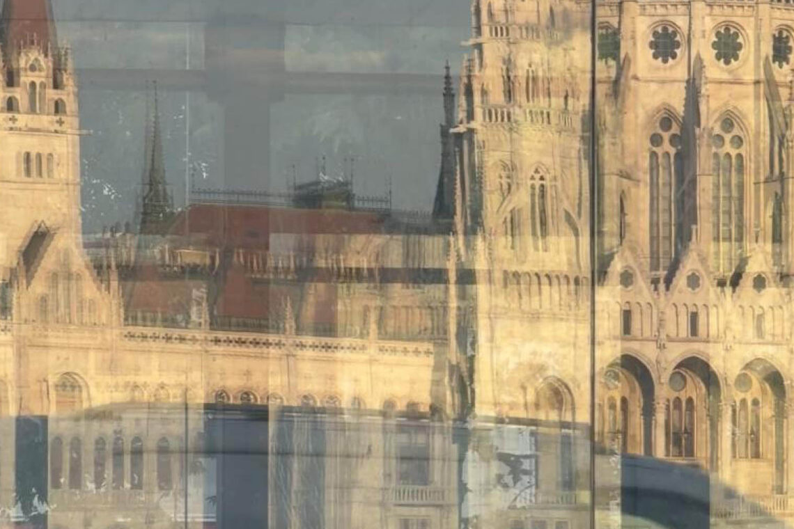 Budapest reflections of the Hungarian Parliament in a glass façade